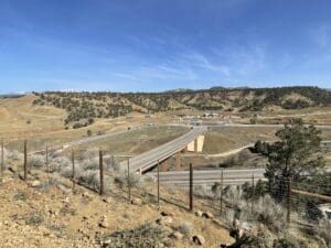 A view of US 550 highway with a fence in the background.