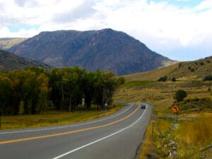A US 50 corridor in the middle of a field with mountains in the background.