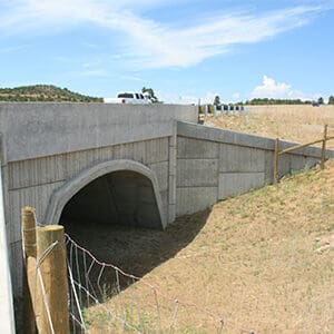A concrete bridge over US 160, providing passing lanes over a road near Dry Creek.