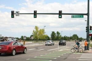 A green traffic light situated on a boulevard.