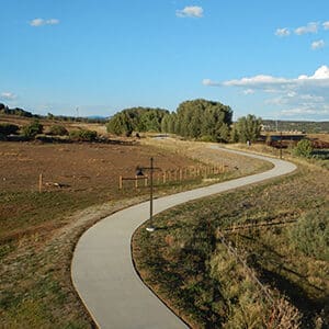 A paved path in a field, part of the SMART trail system.