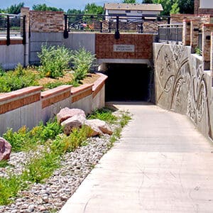 A pedestrian underpass on Sheridan Boulevard with a railing.