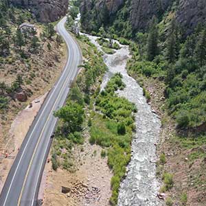 An aerial view of a lower canyon road running parallel to the CO 7 river.