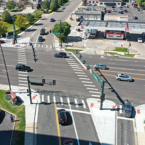 An aerial view of a busy intersection with traffic signals.