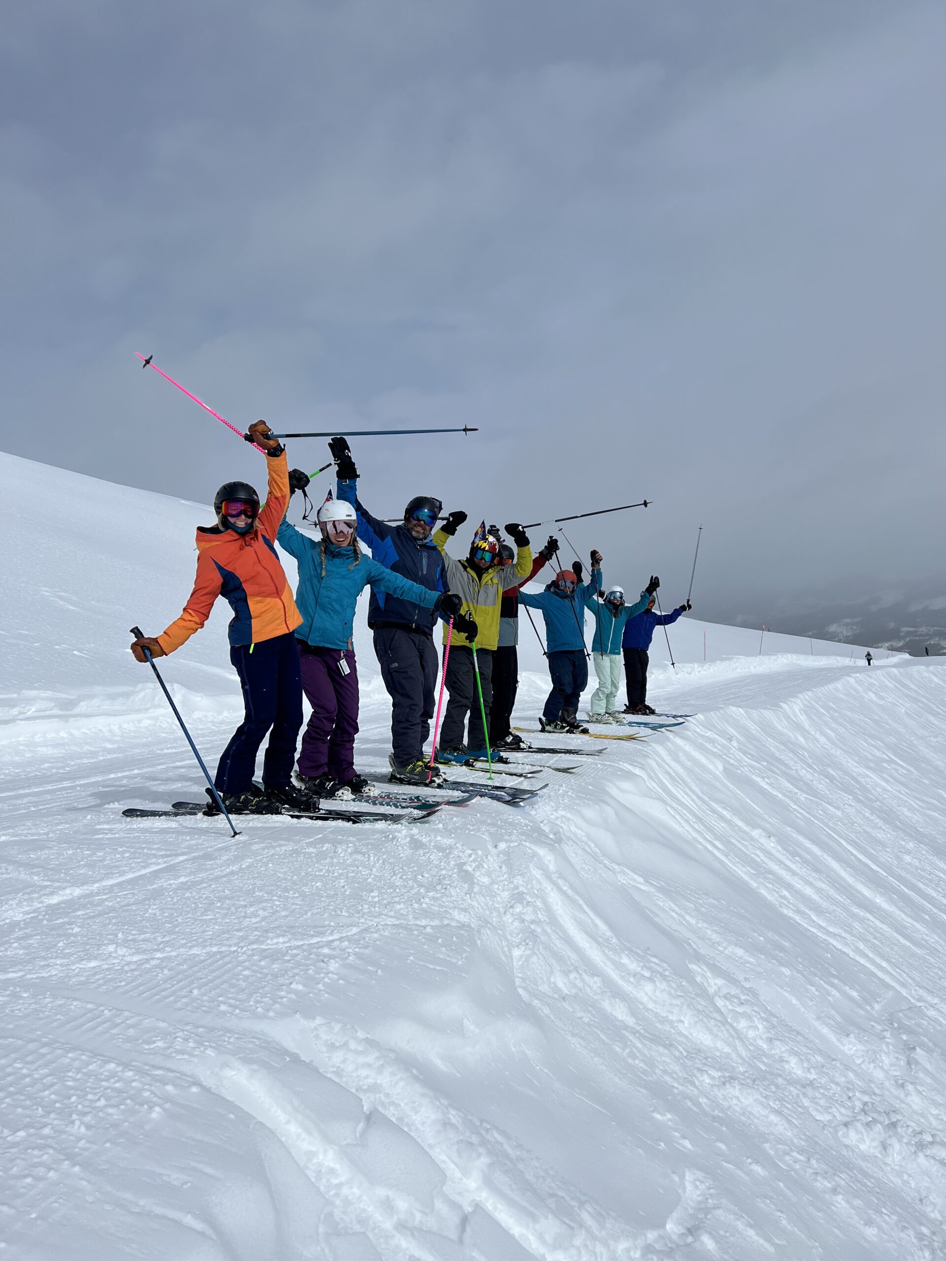 A group of people on skis on a snowy slope.