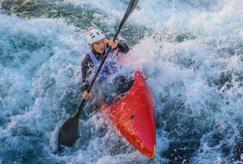 Kayaking through whitewater - recreation and river engineering